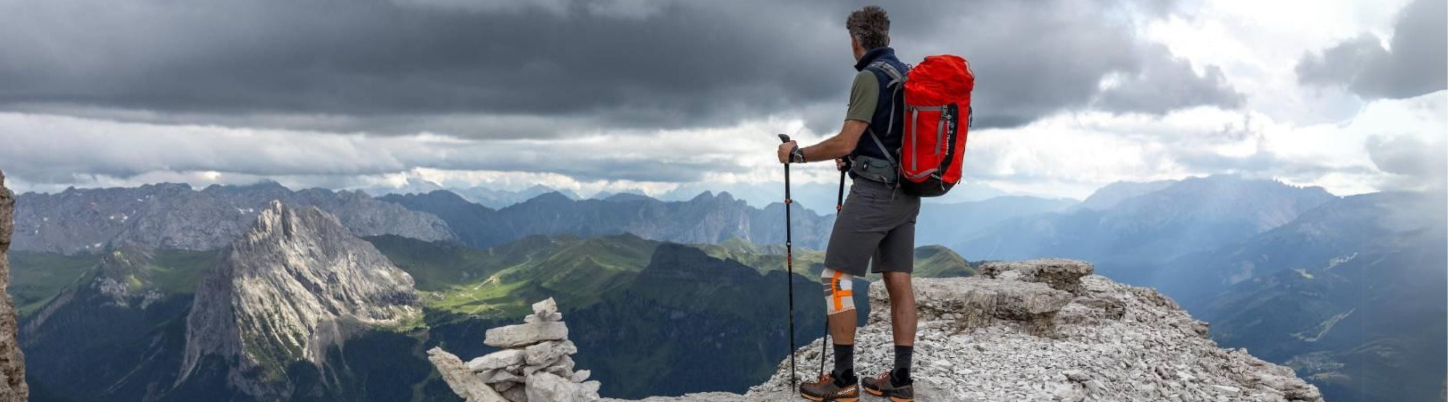 Man wearing Bauerfeind knee brace while riding a bike.