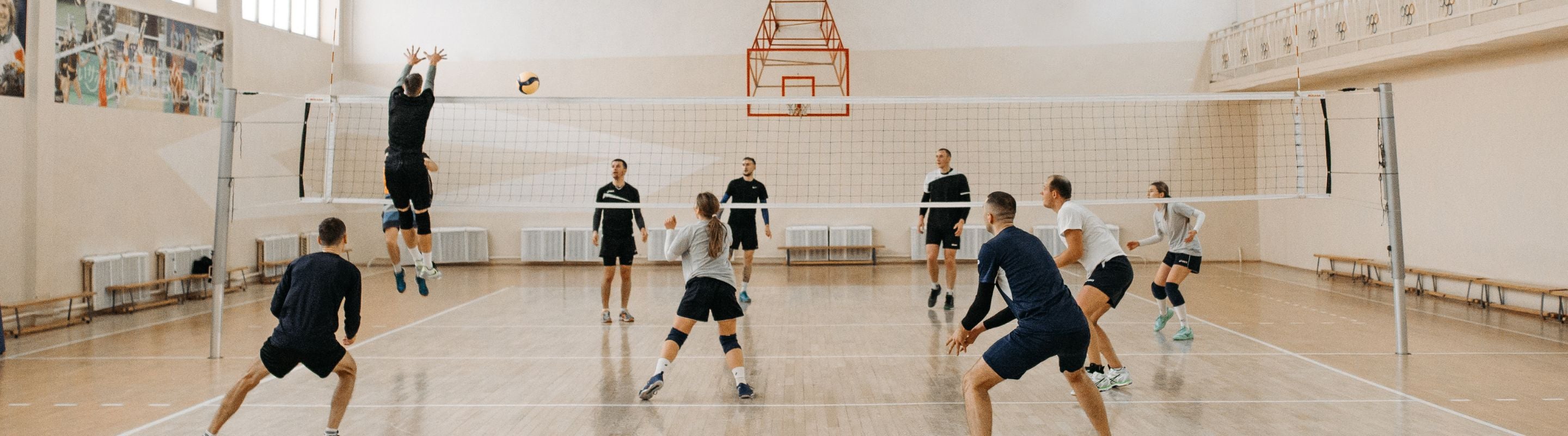 Four people playing volleyball on the court