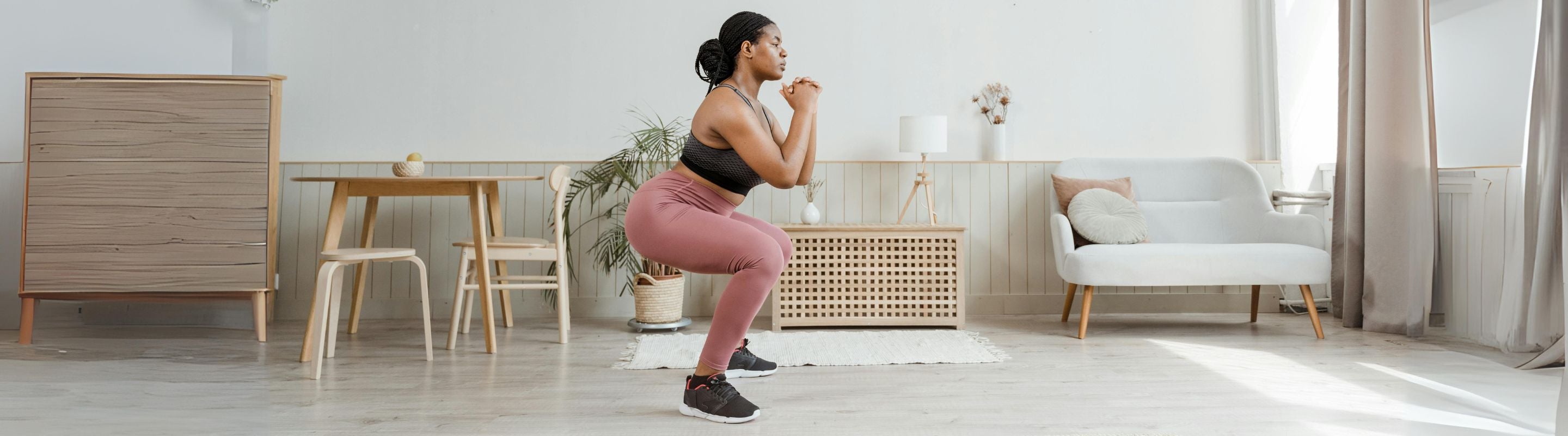 woman doing 90 degree jump turns in her living room