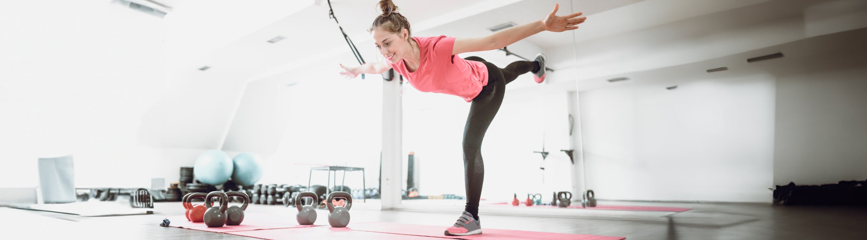 Woman doing the single leg 4 way reach workout for ankle strength and stability