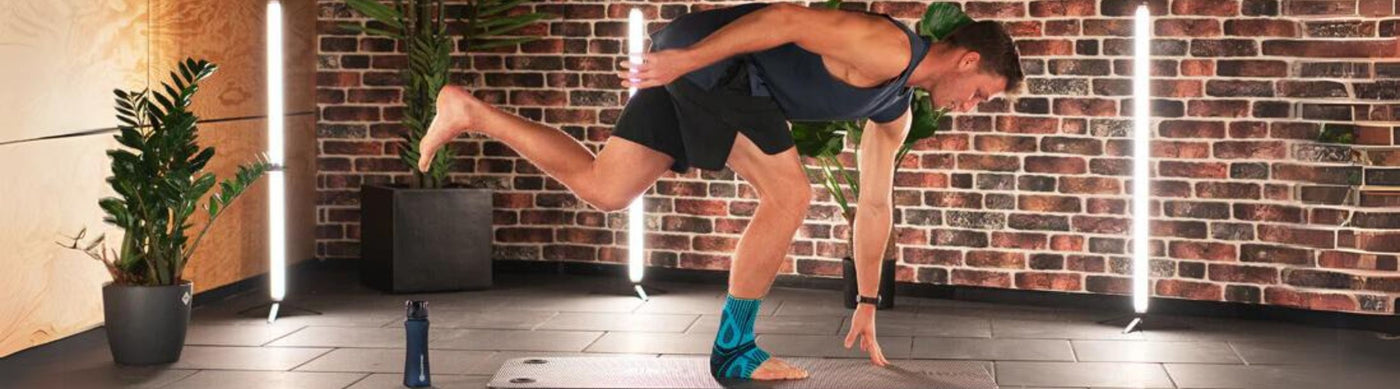 Thomas Roehler performing the single-leg squat touch while wearing Bauerfeind's Sports Achilles Support brace