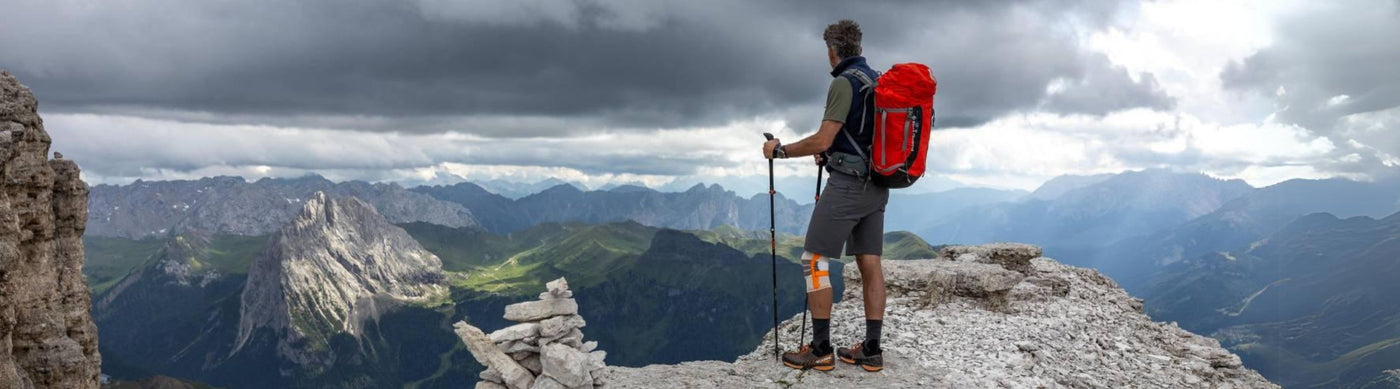 Man Hiking in the mountains. He is wearing Bauerfeind's Outdoor Knee Support