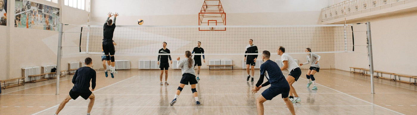Four people playing volleyball on the court