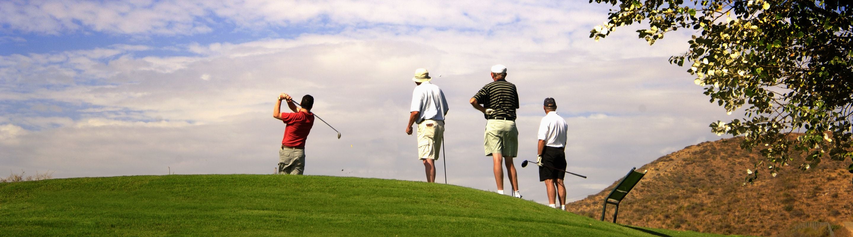 Man in the follow-through of a golf swing