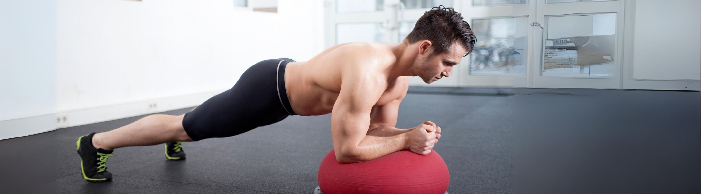 Man doing stability ball planks