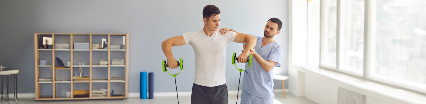 Man doing the banded upright rows exercise with the assistance of a clinician