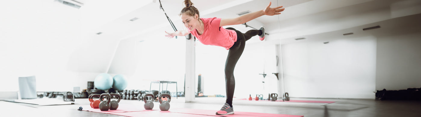 Woman doing the single leg 4 way reach workout for ankle strength and stability 