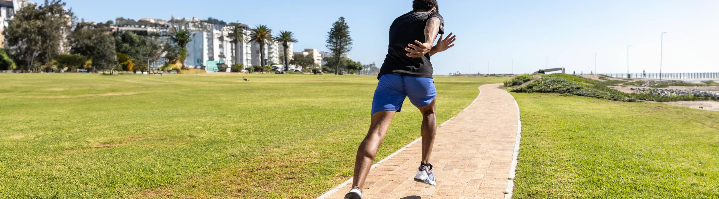 man running through a park. He is using Bauerfeind's run performance insoles