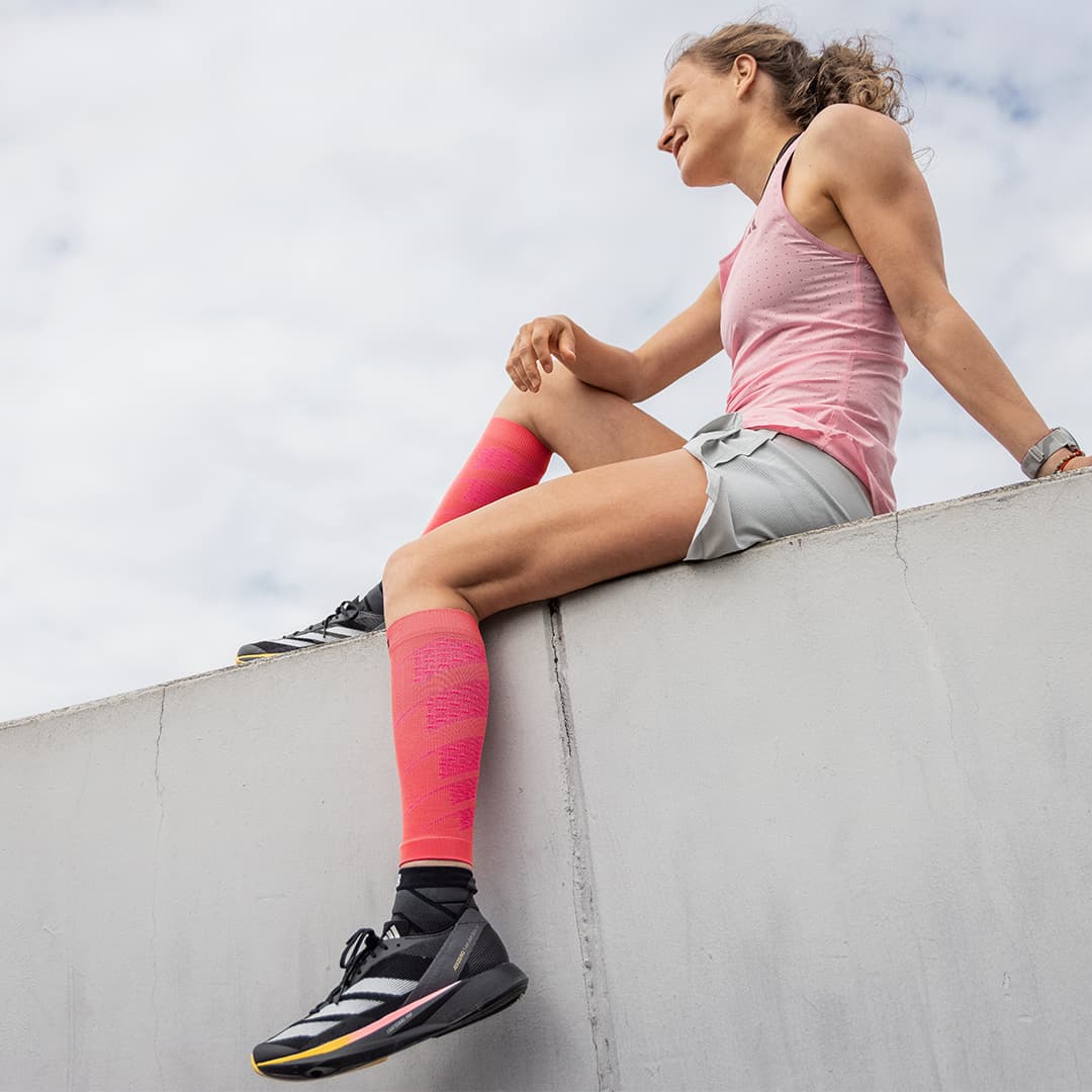 A girl wearing pink Bauerfeind Sports Compression Calf Sleeves Light
