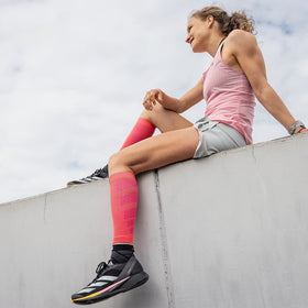 A girl wearing pink Bauerfeind Sports Compression Calf Sleeves Light