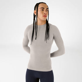 Person wearing a grey Bauerfeind compression long-sleeve shirt against a white background